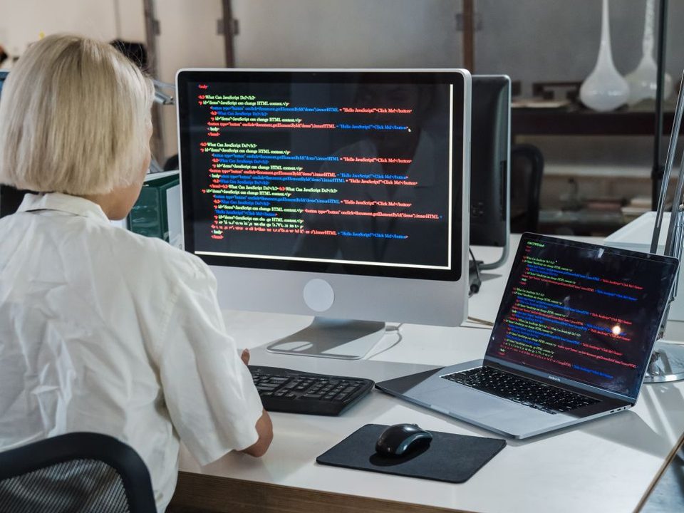 Developer working at a monitor with code